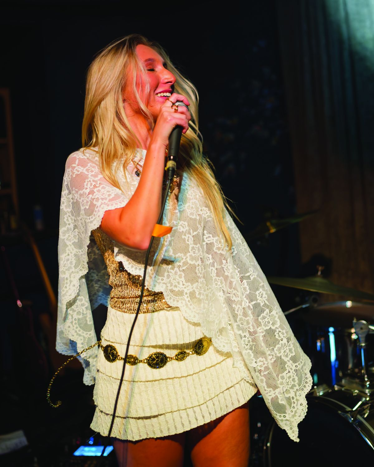 Sylvie smiling and singing in white lace