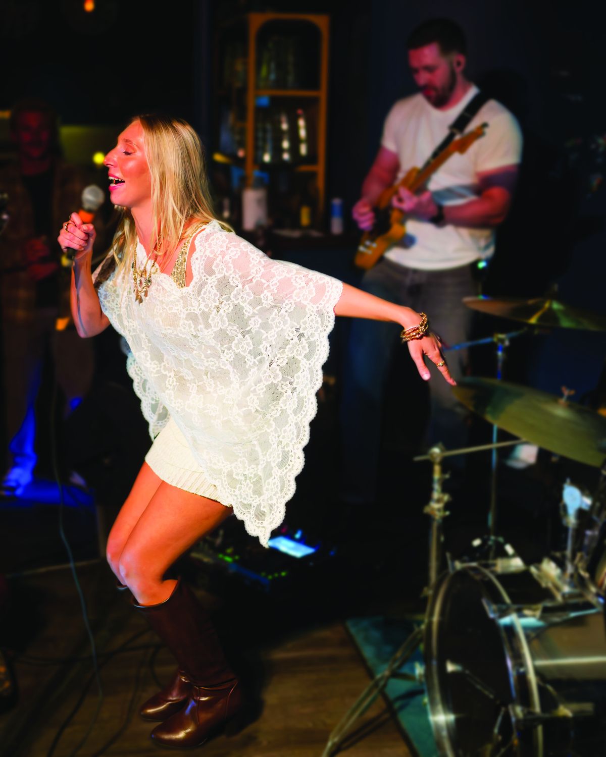 Sylvie dancing in boots in front of the band
