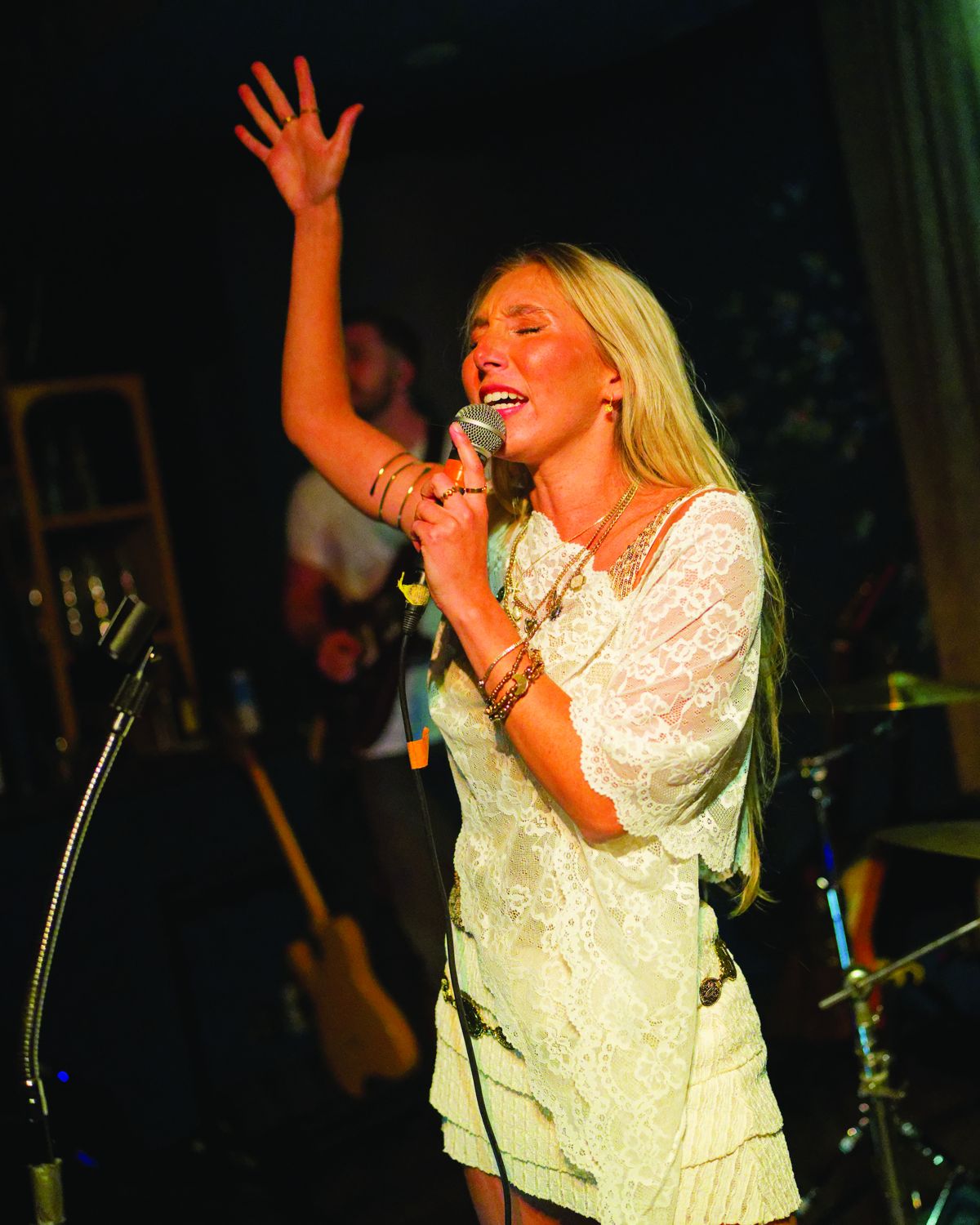 Sylvie singing with her hand in the air