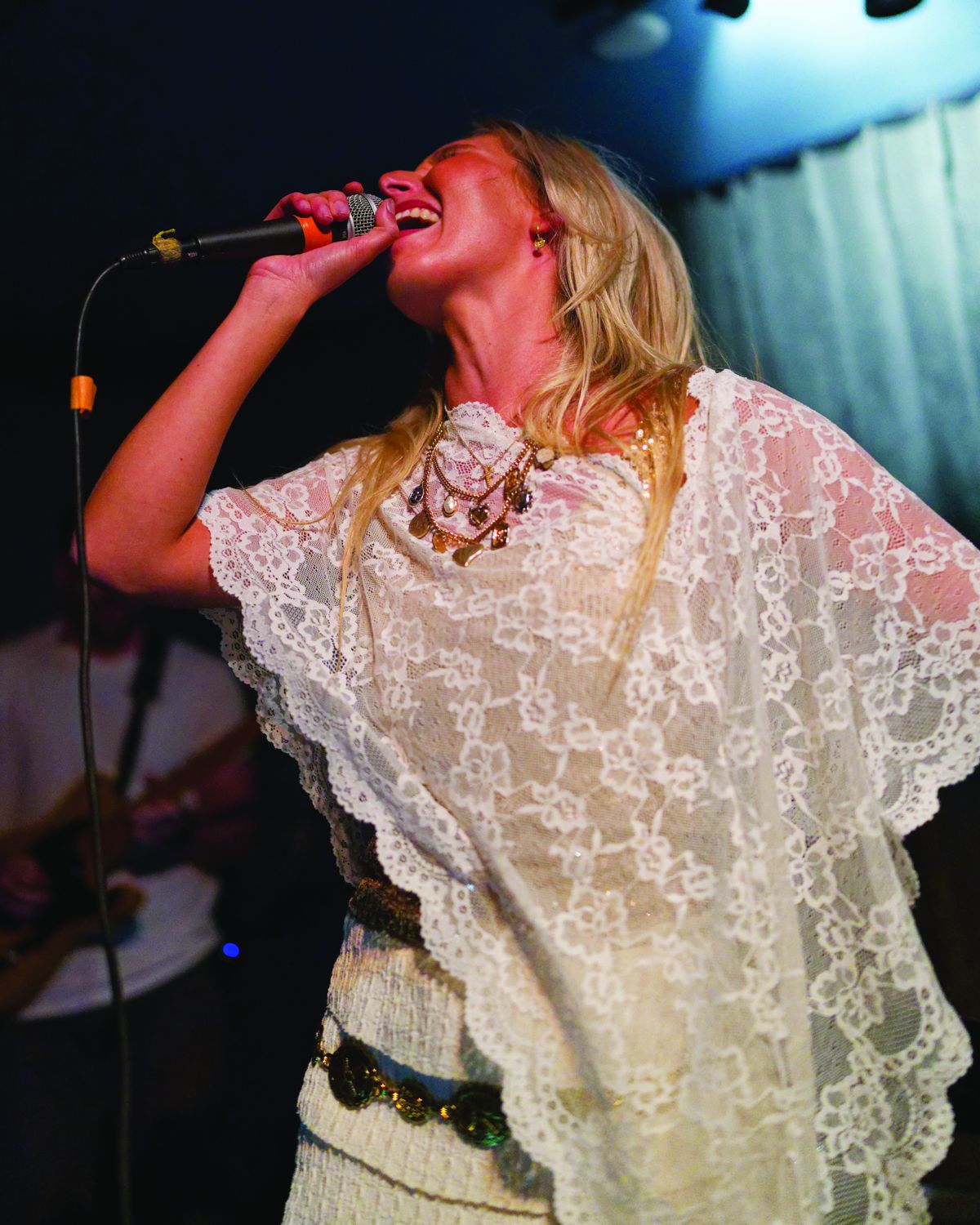 Sylvie singing into the microphone