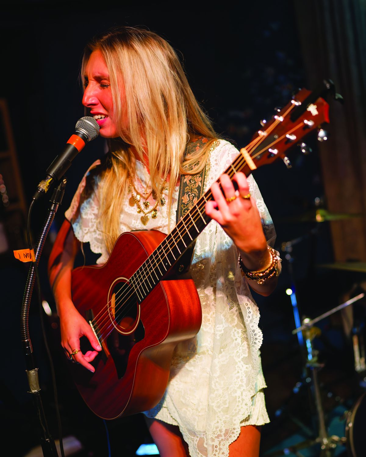 Sylvie playing acoustic guitar and singing